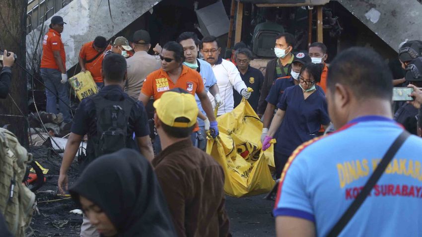 Officers carry a body bag at one of the sites of an attack. in Surabaya, East Java, Indonesia, Sunday, May 13, 2018. Suicide bombers carried out deadly attacks on three churches in Indonesia's second-largest city on Sunday, killing at least 13 people and wounded dozens. (AP Photo)