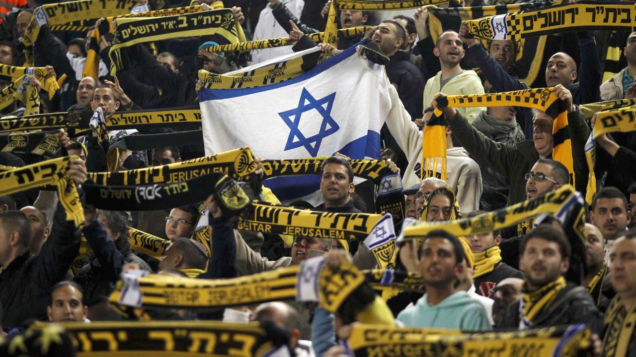 Beitar Jerusalem's supporters chant during an Israeli league game.