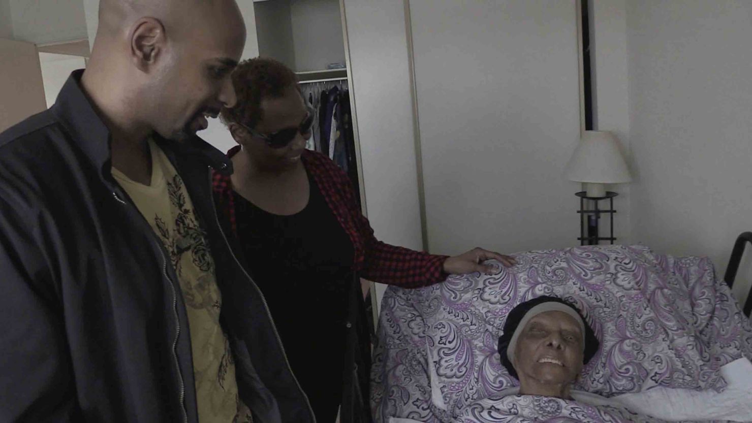 In this May 11 frame from video, family members stop by to visit with Lessie Brown, who is 113, in Cleveland Heights, Ohio. 