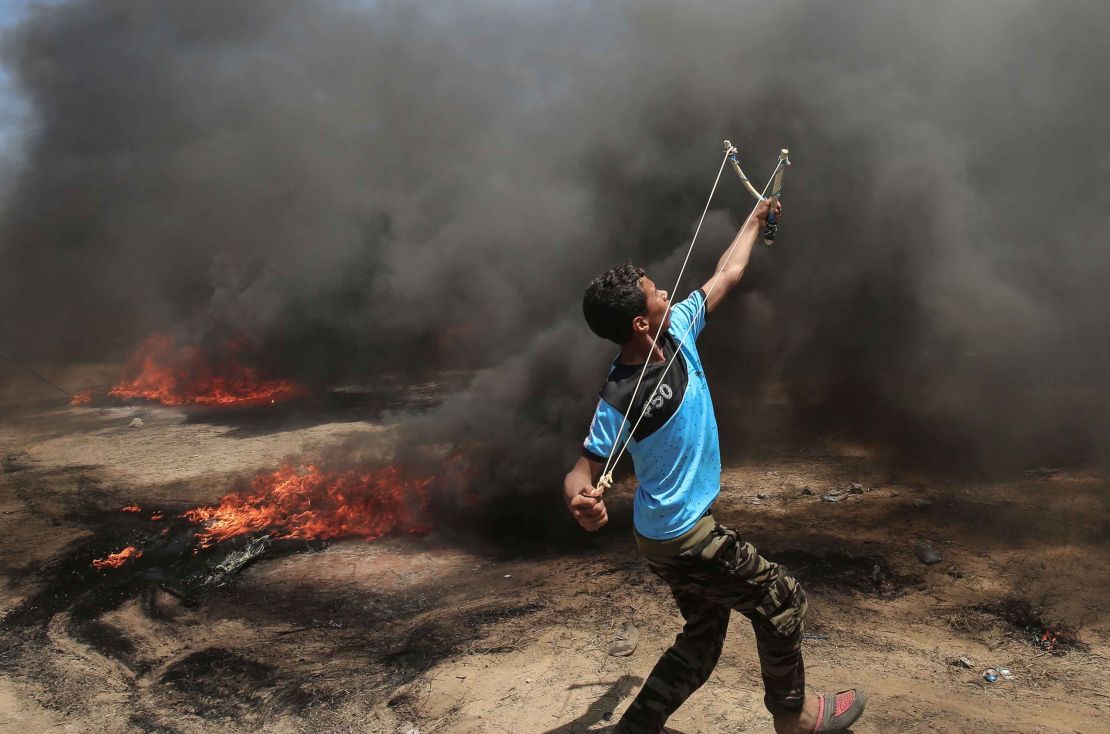 A Palestinian uses a slingshot during clashes with Israeli forces at the Gaza border Monday.