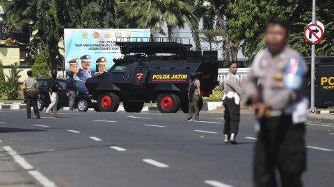 Officers block a road following an attack at the local police headquarters in Surabaya, East Java, Indonesia.