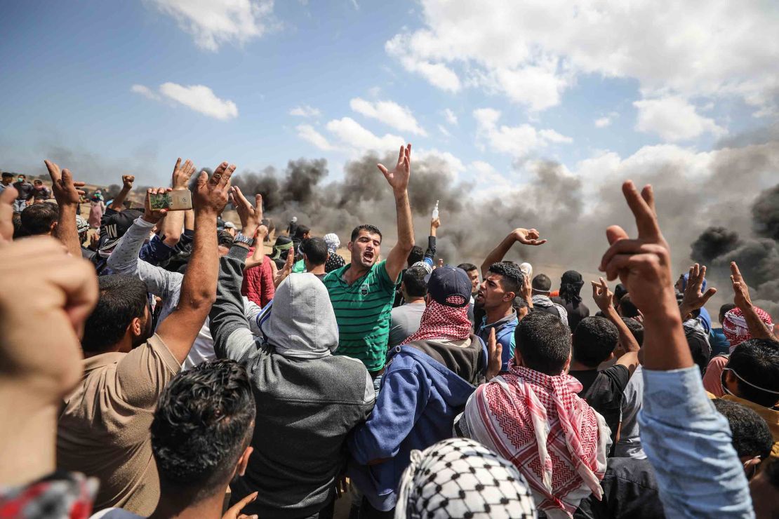 Palestinians carry an injured protester during clashes with Israeli forces in Gaza on Monday. 