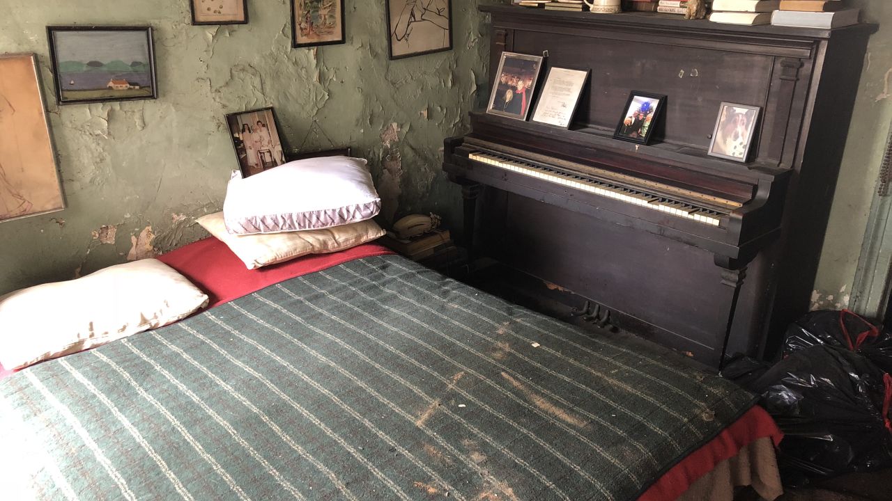 This is O'Grady's bedroom. Her family photos partially cover a wall that's desperate for a paint job. 