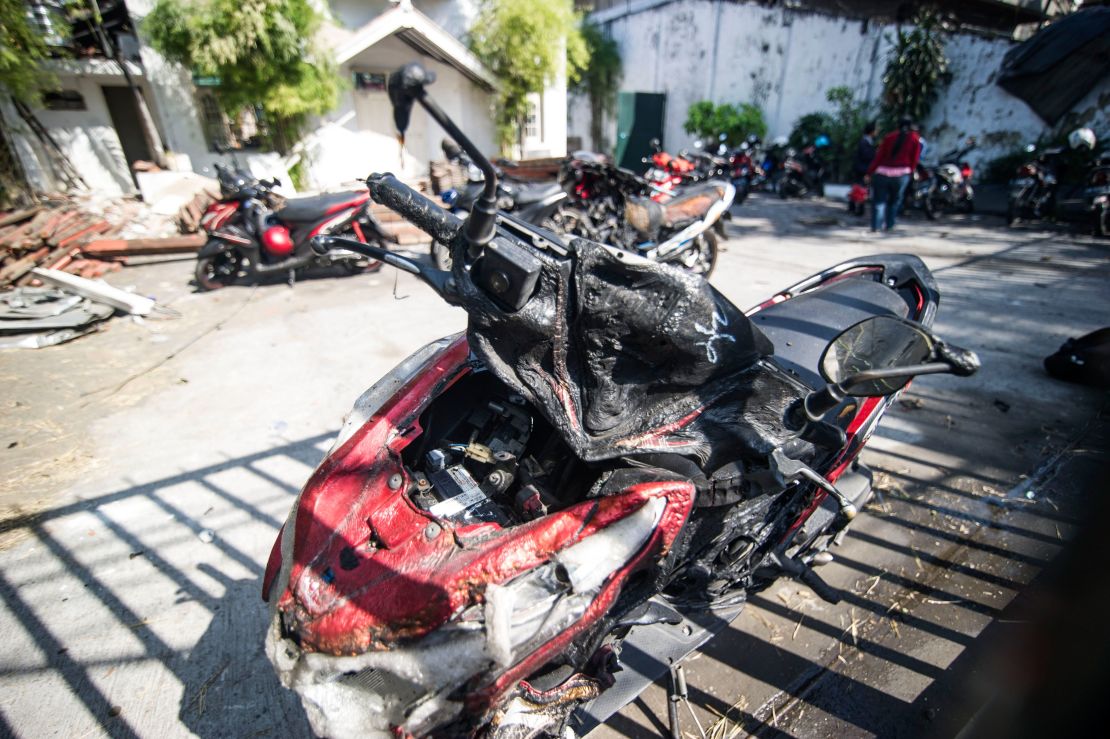 A motorcycle is left damaged outside a Pentecostal church in Surabaya following a blast this week.