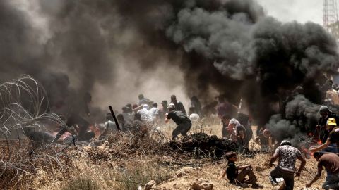 Palestinians clash with Israeli forces near the frontier between Gaza and Israel on May 14. 