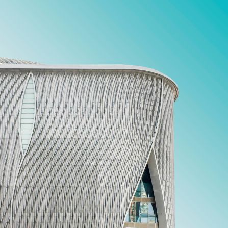 The Xiqu Centre forms part of Hong Kong's new cultural zone, the West Kowloon Cultural District. The building's facade takes the form of a series of interlocking curtains.