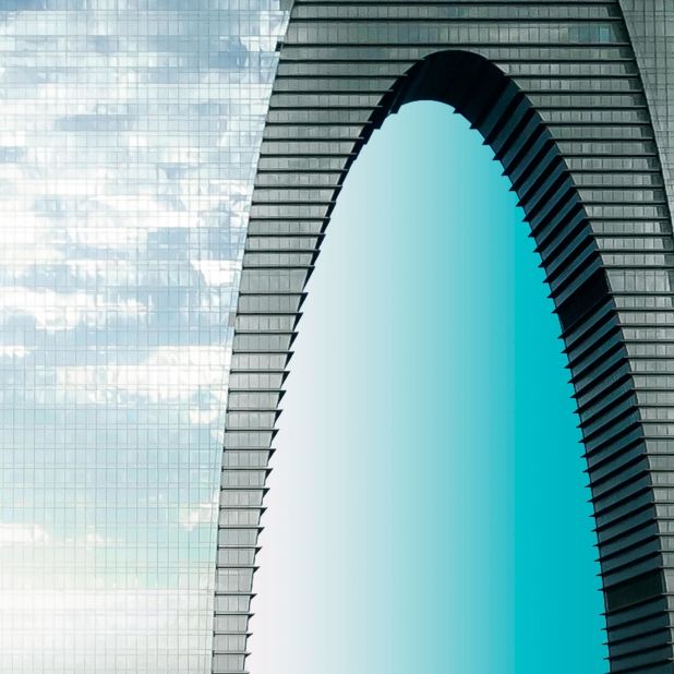 Light reflects off the glass facade of the arched skyscraper, The Gate to the East, offering a new perspective on one of Suzhou's most recognizable buildings.