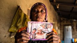 Rebecca Sharibu, 45, holds up a photograph that shows her daughter Leah, seated on the left in a black shirt. Leah was kidnapped in February 2018 from her school in the town of Dapchi in northern Nigeria by Boko Haram. Photo by Chika Oduah.