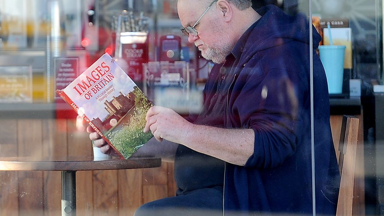 Thomas Markle reading a book titled "Images of Britain," in an allegedly staged photo.
