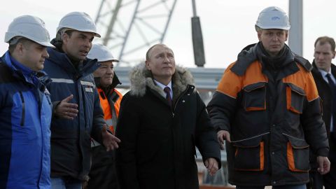 Russian President Vladimir Putin (C) inspects the road section of the road-and-rail Crimean Bridge over the Kerch Strait on March 14, 2018. / AFP PHOTO / POOL / YURI KOCHETKOV (Photo credit should read YURI KOCHETKOV/AFP/Getty Images)
