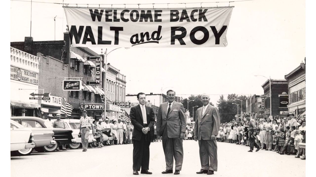 Walt, center, and Roy Disney, right, returned to Marceline in 1956 to dedicate the town's swimming pool with Marceline's mayor, left. They also stopped by their childhood home and school. 