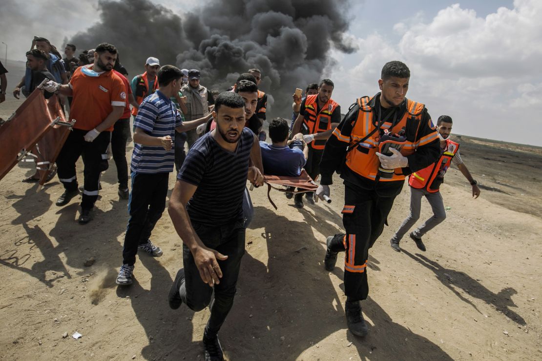 Medical units carry away a wounded Palestinian during a protest at the Gaza border on Monday. 