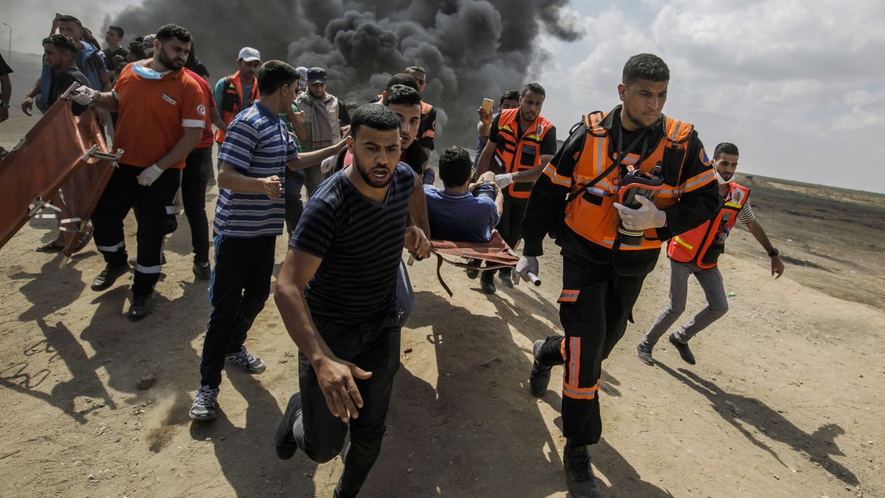 Medical units carry away a wounded Palestinian during a protest at the Gaza border on Monday. 