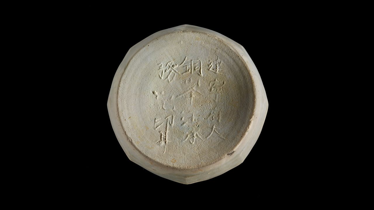 A ceramic box base with a Chinese inscription that mentions a place where it was probably made, Jianning Fu, which dates from A.D. 1162 to 1278. 