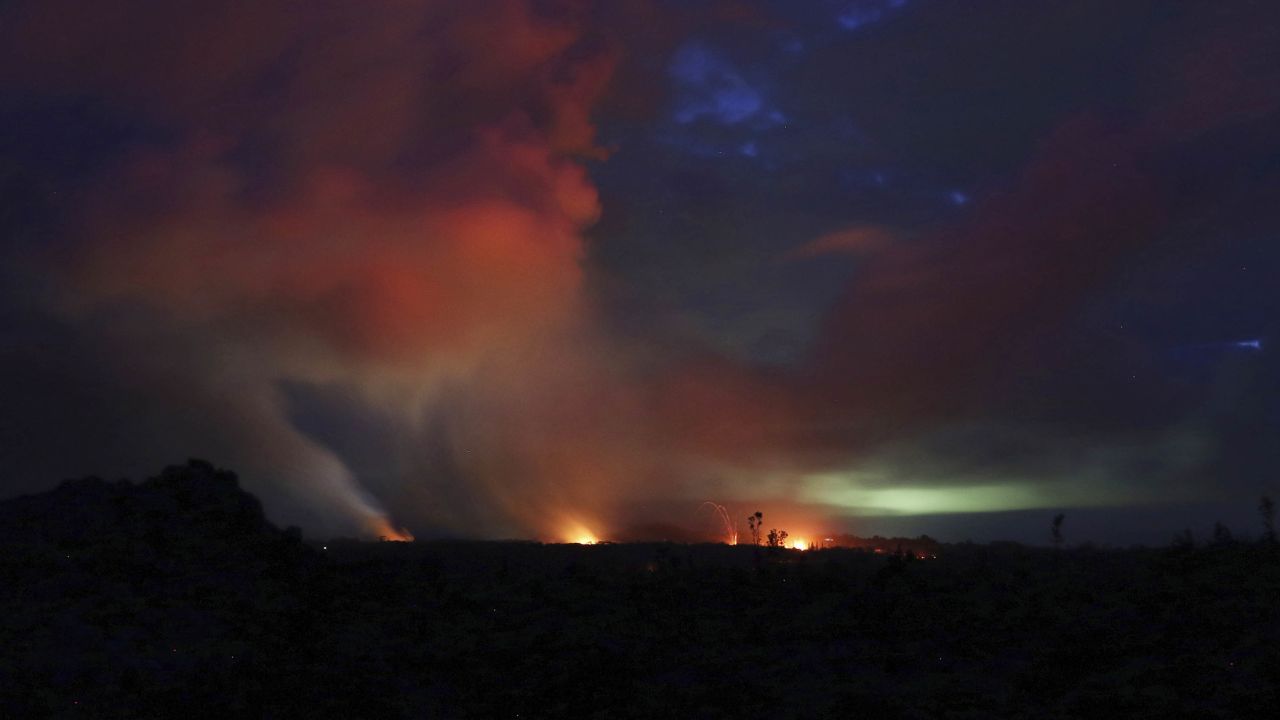 Lava shoots into the night sky from active fissures on the lower east rift of Kilauea volcano, Tuesday, May 15, 2018 near Pahoa, Hawaii. (AP Photo/Caleb Jones)