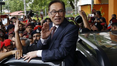 Malaysia's reformist icon Anwar Ibrahim, center, waves to his supporters and journalists after leaving a hospital in Kuala Lumpur, Wednesday, May 16.