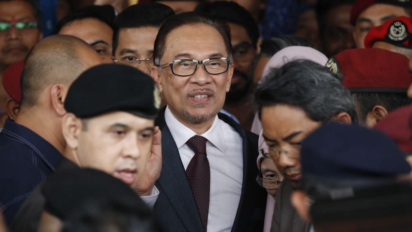 Malaysia jailed opposition icon Anwar Ibrahim waves to supporters as he leave a hospital in Kuala Lumpur, Malaysia, Wednesday, May 16, 2018. Prime Minister Mahathir Mohamad said Malaysia's king had agreed to pardon Anwar, who was jailed in 2015 for sodomy in a conviction that he said was politically motivated. (AP Photo/Vincent Thian)