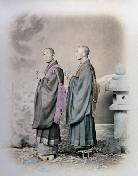 Two young Buddhist monks hold the rosary in their hands. 