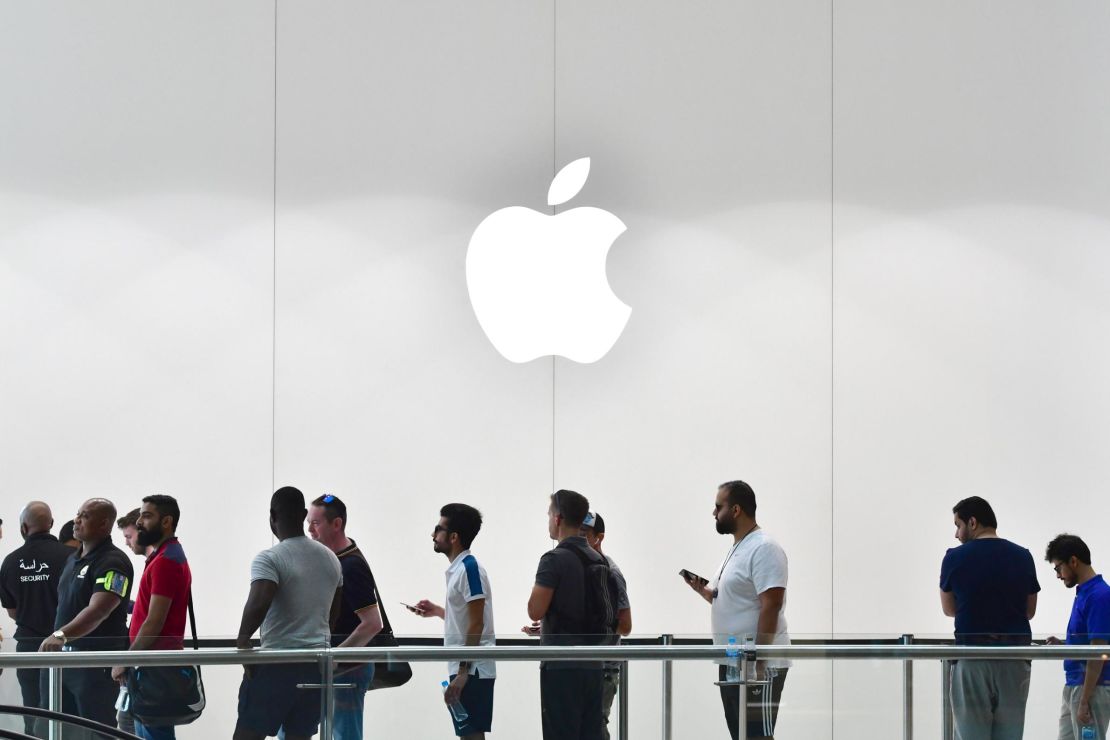 Customers stand in line at the Apple store in Dubai Mall.