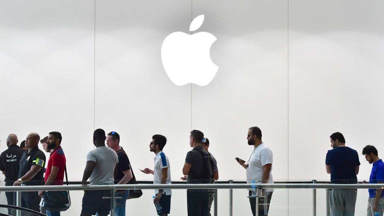 Customers stand in line at the Apple store in Dubai Mall.