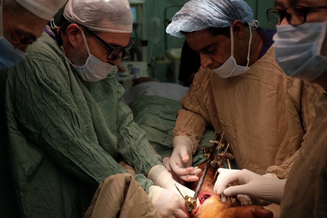 Abu-Sitta operating on a patient with a limb injury.