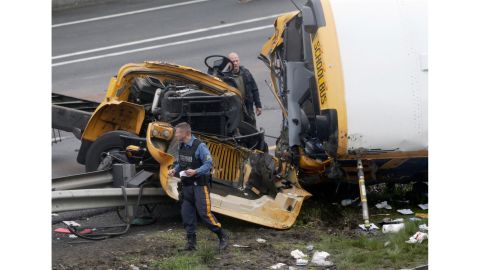 Emergency personnel work at the scene of a school bus and dump truck collision on Interstate 80 on May 17.