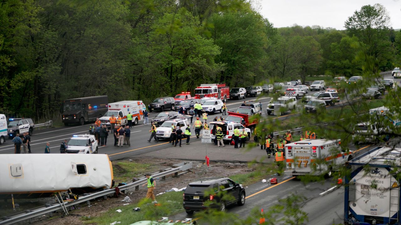 Emergency personnel work at the scene of a school bus and dump truck collision on Interstate 80 in Mount Olive Township, New Jersey.