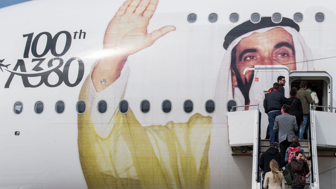 Passengers board an Emirates A380 Airbus with a giant portrait of UAE founding father Zayed bin Sultan Al Nahyan, to celebrate the centenary of his birth, in April 2018. 