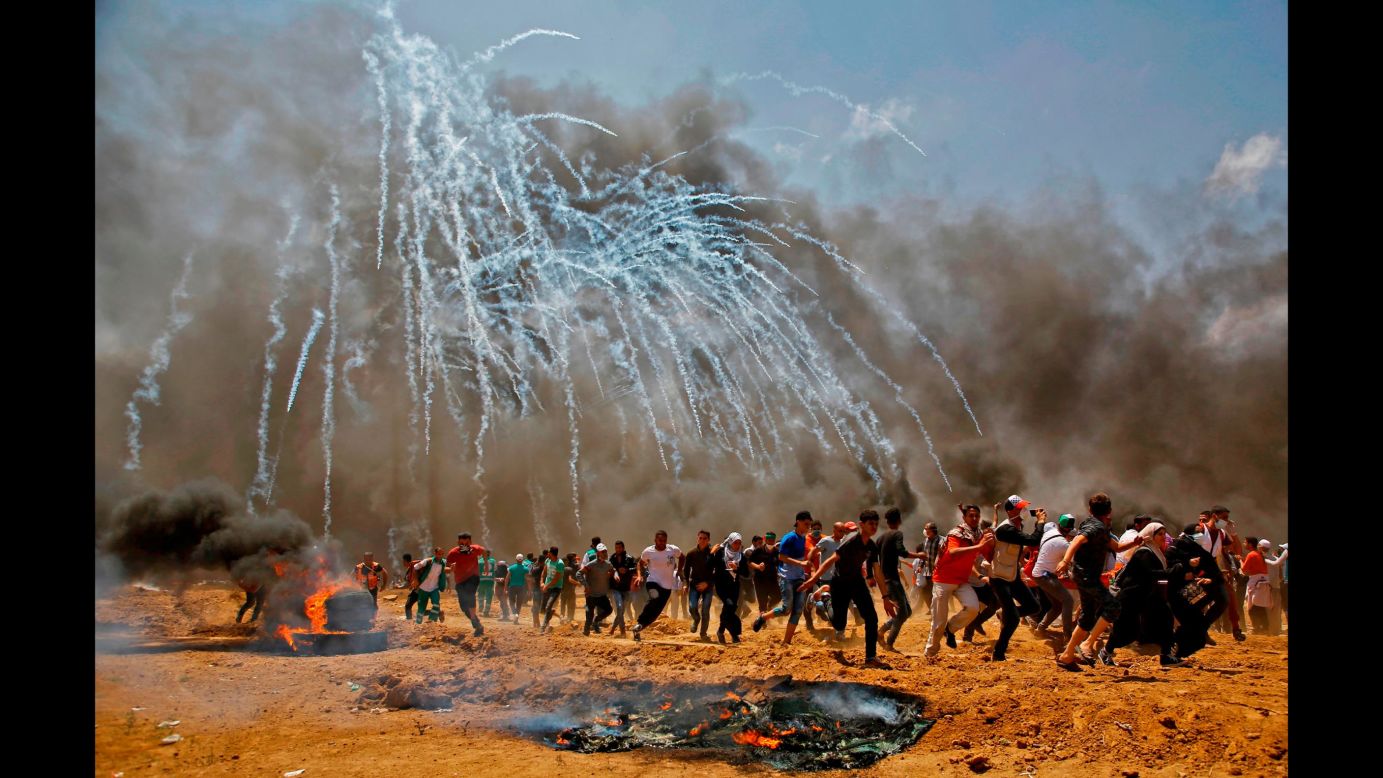 Tear gas rains down on Palestinians near the Israeli-Gaza border on Monday, May 14. According to the Palestinian Health Ministry, <a href="https://www.cnn.com/2018/05/14/middleeast/gaza-protests-intl/index.html" target="_blank">dozens of Palestinians were killed by Israeli forces </a>during protests over the new US Embassy in Jerusalem. Palestinian officials accused Israel of committing a "horrific massacre" and called on the international community to intervene. Israeli Prime Minister Benjamin Netanyahu defended his military's actions, tweeting that "every country has the duty to defend its borders." Israel's military said protesters threw Molotov cocktails, stones and burned tires at Israeli soldiers positioned along the fence separating Israel and Gaza.