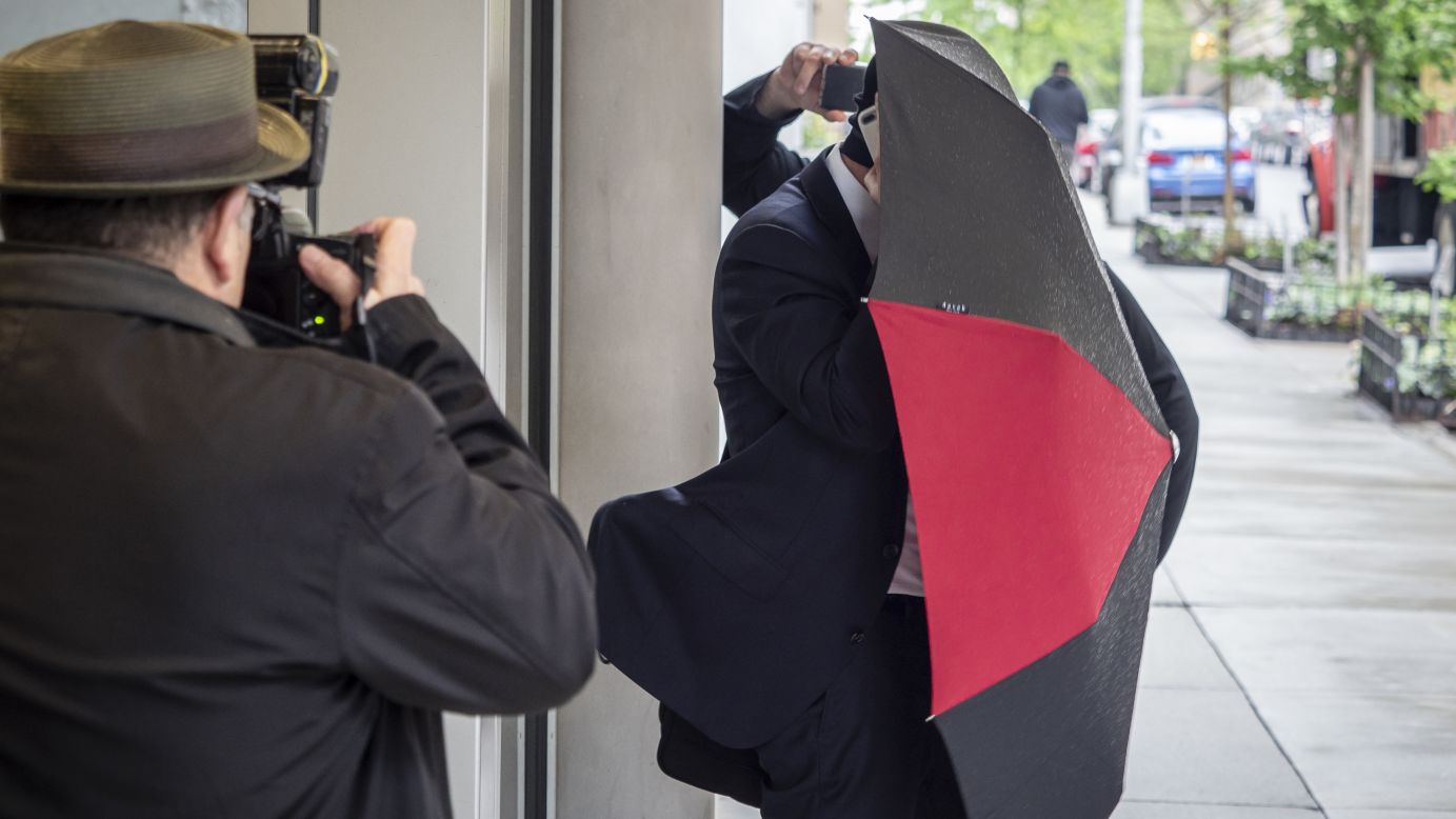 Aaron Schlossberg, the attorney who berated employees and customers for speaking Spanish in a New York restaurant, covers himself with an umbrella as he leaves his home in Manhattan on Thursday, May 17. <a href="https://www.cnn.com/2018/05/17/us/new-york-man-restaurant-ice-threat/index.html" target="_blank">The restaurant encounter </a>happened Tuesday, according to Edward Suazo, who posted a video of it on Facebook. The video had been viewed 4.4 million times by early Thursday.