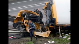 Emergency personnel work at the scene of a school bus and dump truck collision, injuring multiple people, on Interstate 80 in Mount Olive, N.J., Thursday, May 17, 2018. (AP Photo/Seth Wenig)