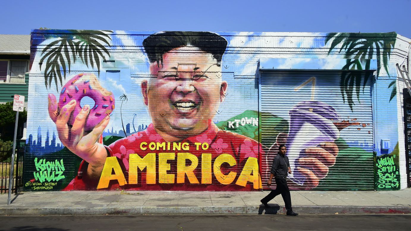 A pedestrian walks past a mural in Los Angeles that depicts North Korean leader Kim Jong Un on Monday, May 14 The mural is in the city's Koreatown neighborhood, and it was created by graffiti artists @welinoo, @balstroem and @sorenarildsen as part of the Ktown Wallz Project.