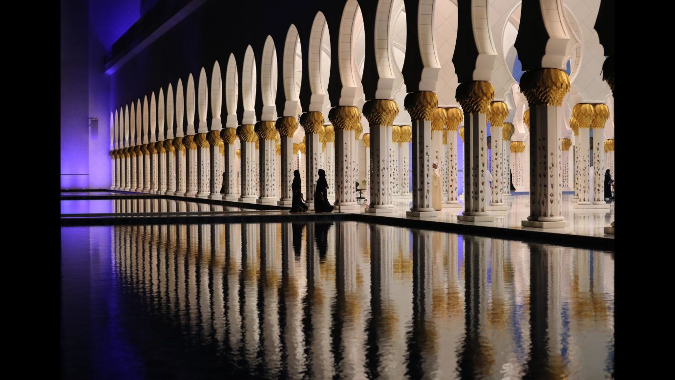 People walk Wednesday, May 16, at the Sheikh Zayed Grand Mosque in Abu Dhabi, United Arab Emirates. Ramadan, the Islamic holy month of fasting, began at sundown on Tuesday.