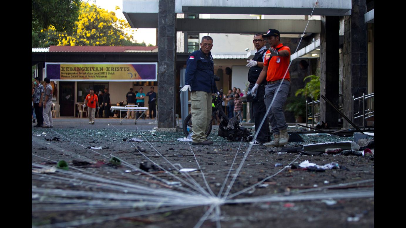 A forensics team examines the scene of a church bombing in Surabaya, Indonesia, on Sunday, May 13. A husband and wife used their four children in a string of <a href="https://www.cnn.com/2018/05/13/asia/indonesia-church-attacks-surabaya/index.html" target="_blank">deadly suicide attacks on three churches,</a> according to the country's ranking police official.