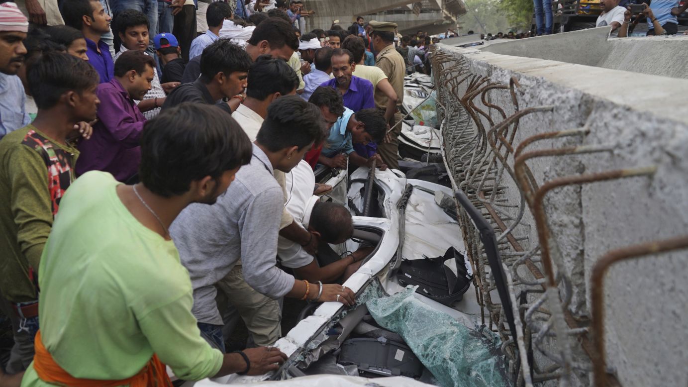 People look for survivors inside vehicles that were crushed when <a href="https://www.cnn.com/2018/05/16/asia/india-overpass-collapse-varanasi-15-dead-intl/index.html" target="_blank">a section of a partially constructed overpass collapsed </a>in Varanasi, India, on Tuesday, May 15. At least 15 people were killed.