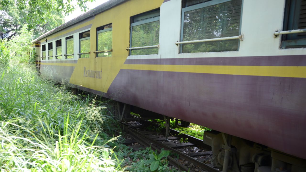 <strong>Dining car: </strong>A restaurant car rests amongst the weeds for now but could one day be back on Thailand's rails.
