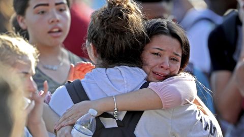Students embrace after a February 14 shooting at Marjory Stoneman Douglas High School in Parkland, Florida.