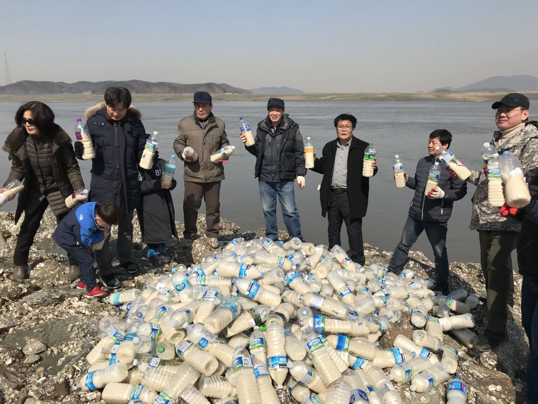 Activists in South Korea pose with bottled care packs for the North near the DMZ