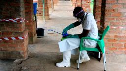 In this photo taken on Sunday, May 13, 2018, a health care worker wears virus protective gear at a treatment center in Bikoro Democratic Republic of Congo. Congo's latest Ebola outbreak has spread to a city of more than 1 million people, a worrying shift as the deadly virus risks traveling more easily in densely populated areas. Two suspected cases of hemorrhagic fever were reported in the Wangata health zones that include Mbandaka, the capital of northwestern Equateur province. The city is about 150 kilometers (93 miles) from Bikoro, the rural area where the outbreak was announced last week, said Congo's Health Minister Oly Ilunga. (AP Photo/John Bompengo)