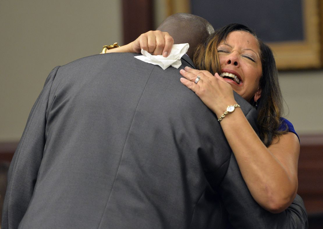 McBath hugs Jordan's father, Ron Davis, during a 2014 sentencing hearing for her son's killer in Jacksonville, Florida.  