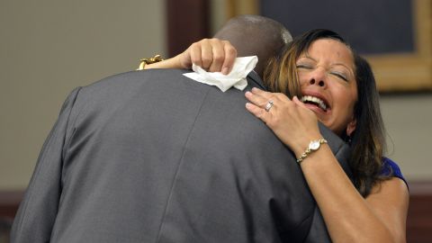 McBath hugs Jordan's father, Ron Davis, during a 2014 sentencing hearing for her son's killer in Jacksonville, Florida.  