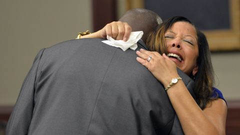 McBath hugs Jordan's father, Ron Davis, during a 2014 sentencing hearing for her son's killer in Jacksonville, Florida.