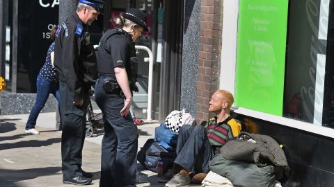 A police officer talks to a homeless man in Windsor on May 17, 2018, two days before the royal wedding.