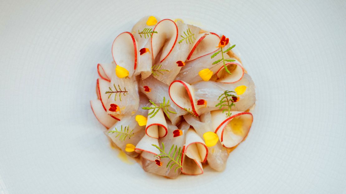This colorful dish made of  kampachi, almond butter and nectarines can be found at Petit Crenn.