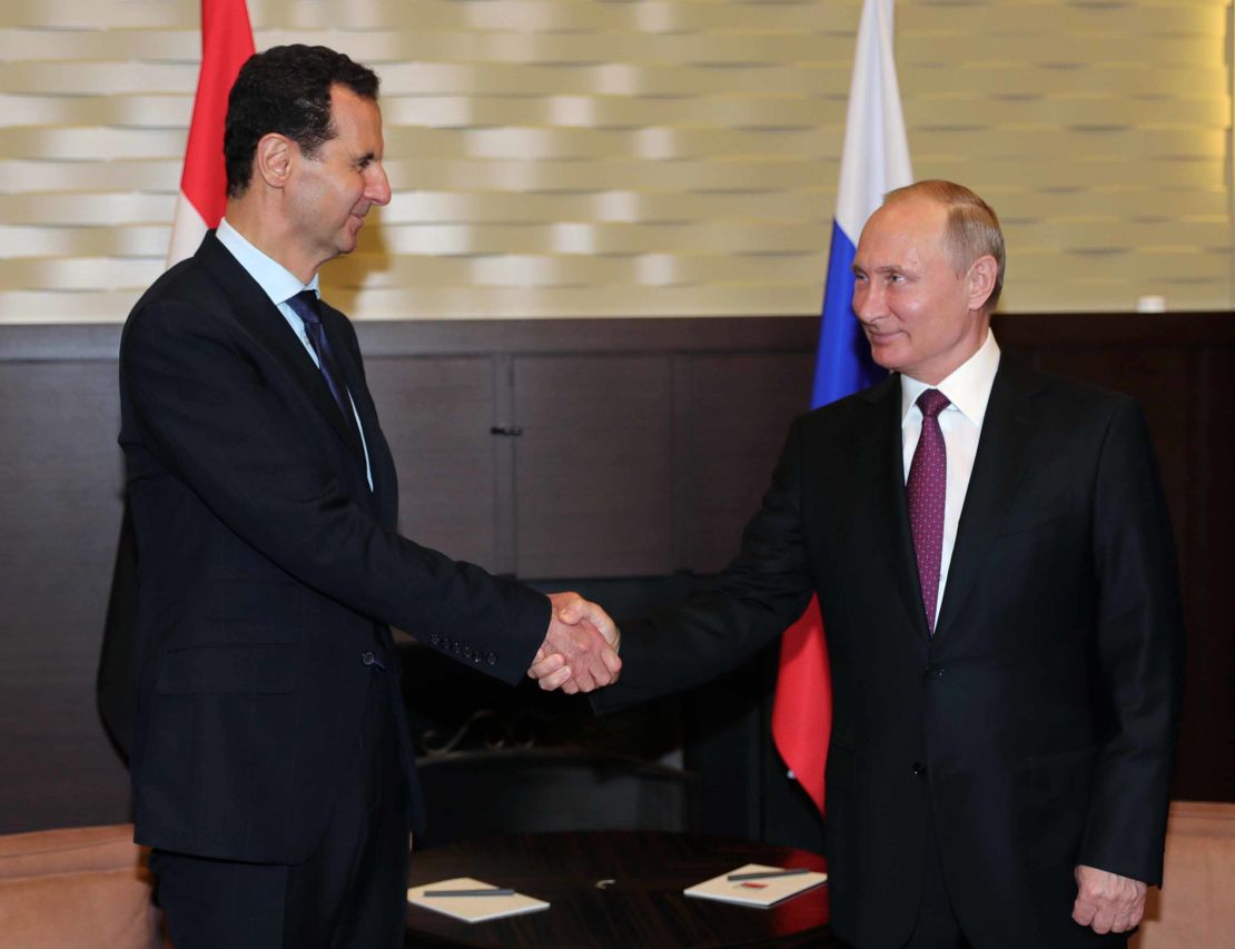 Russian President Vladimir Putin  shakes hands with his Syrian counterpart Bashar al-Assad during a meeting in Sochi on May 17, 2018.