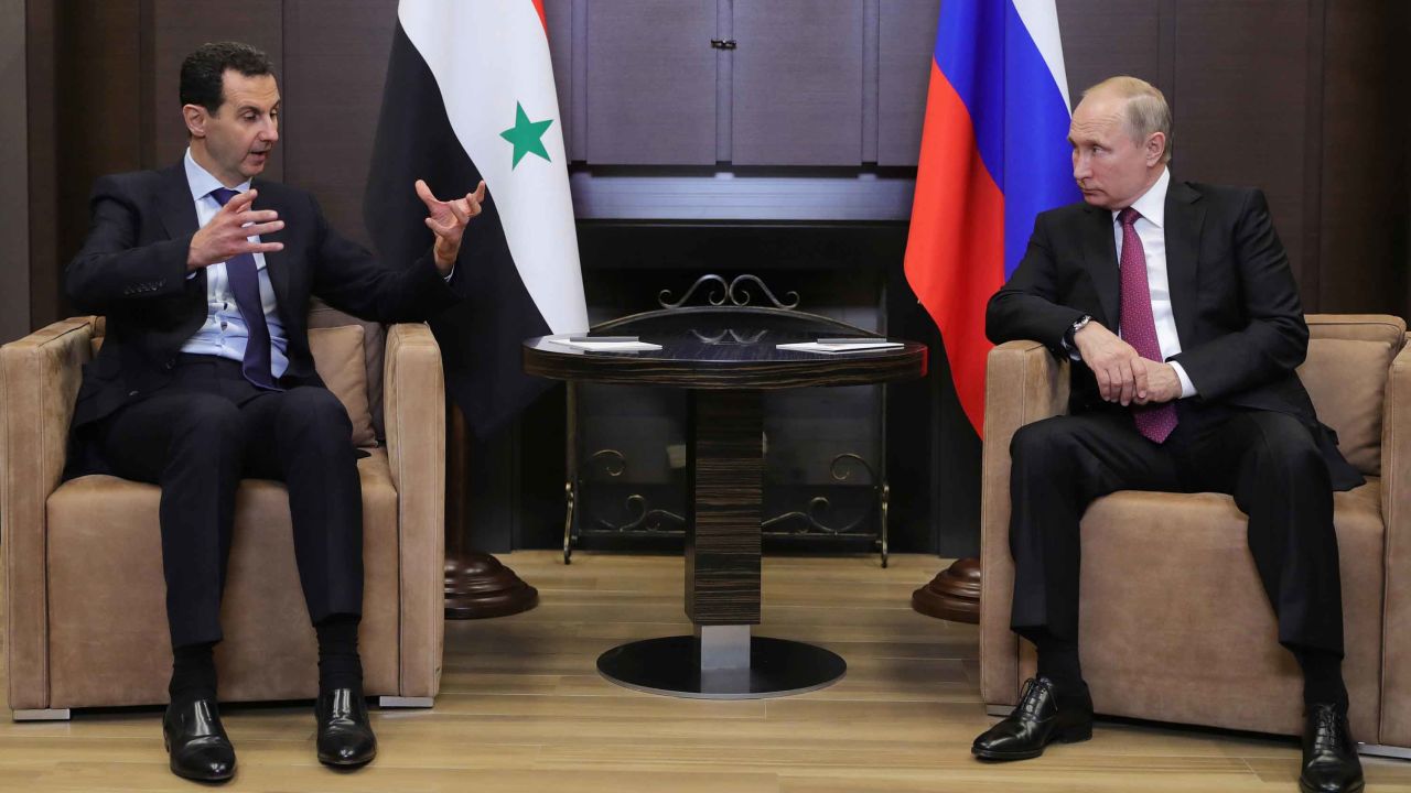 Russian President Vladimir Putin speaks with his Syrian counterpart Bashar al-Assad during their meeting in Sochi on May 17, 2018. 