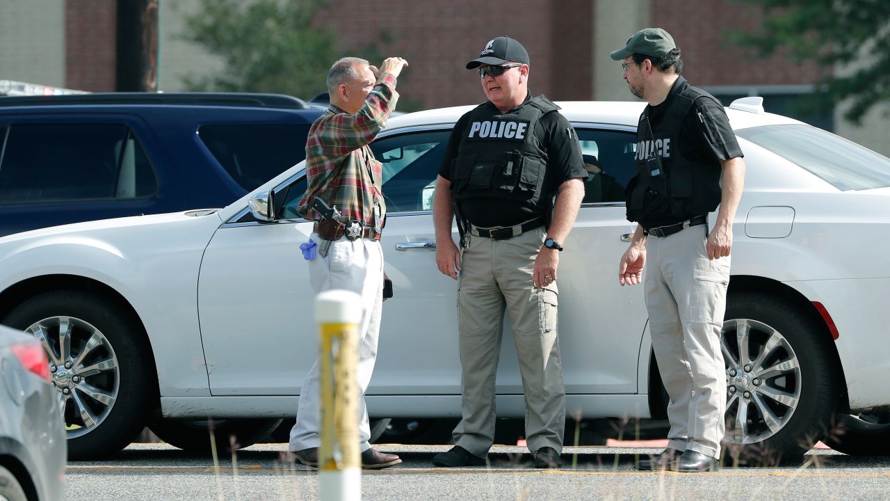 Police officers work a checkpoint in front of Santa Fe High School in response to the shooting.
