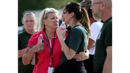 Santa Fe High School staff react as they gather in the parking lot of a gas station following a shooting at the school in Santa Fe, Texas, on Friday, May 18, 2018.   (Jennifer Reynolds/The Galveston County Daily News via AP)