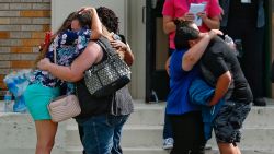 People embrace outside the Alamo Gym where students and parents wait to reunite following a shooting at Santa Fe High School Friday, May 18, 2018, in Santa Fe, Texas. ( Michael Ciaglo/Houston Chronicle via AP)