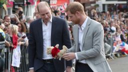 Britain's Prince Harry (R) and Prince Harry's brother and best man Prince William, Duke of Cambridge look at a teddy bear, given to Hary as a gift by a well-wisher on the street outside Windsor Castle in Windsor on May 18, 2018, the eve of Britain's Prince Harry's royal wedding to US actress Meghan Markle. - Britain's Prince Harry and US actress Meghan Markle will marry on May 19 at St George's Chapel in Windsor Castle. (Photo by Jonathan Brady / POOL / AFP)        (Photo credit should read JONATHAN BRADY/AFP/Getty Images)